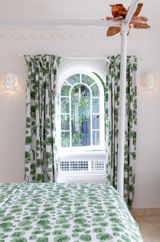 This image shows a bedroom with a botanical theme