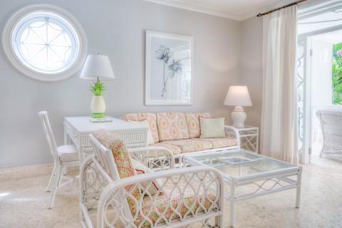 This image shows a brightly lit, inviting interior room with coastal-style decor