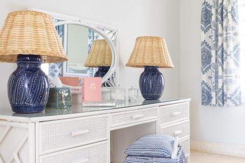 This image features a bright and elegantly decorated room corner, reflecting a coastal or tropical style
