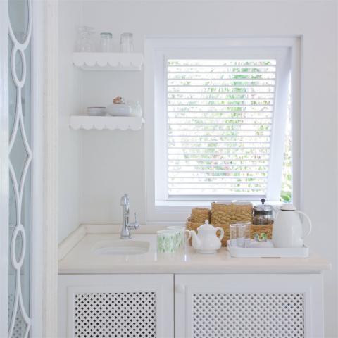 This image shows a neatly organized kitchen counter and shelving area