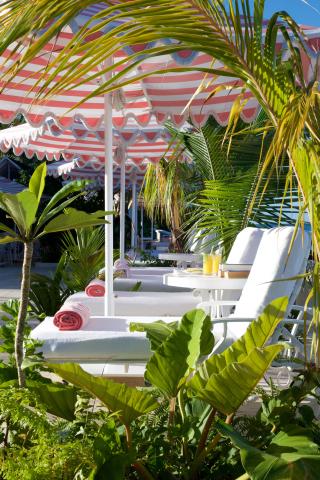 The image showcases an appealing outdoor lounge area that creates a relaxing atmosphere, likely belonging to a resort or spa