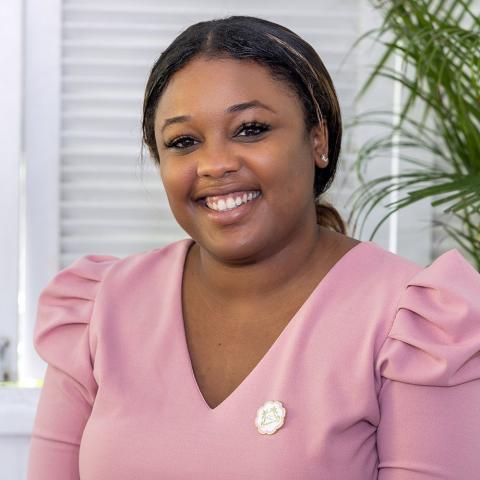 The image shows a woman smiling at the camera