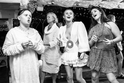 This black and white image captures a lively scene at what appears to be a festive gathering or party