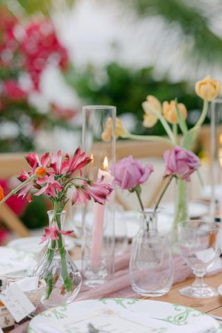 The image shows a beautifully arranged table setting which appears to be set up for a formal event, likely a wedding or a celebratory banquet