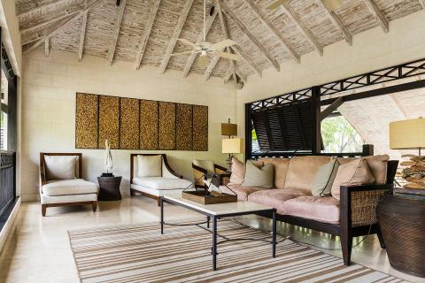 This image shows a stylish and elegant interior, likely a living room within a tropical or subtropical setting