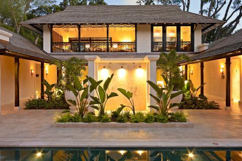 This image features a luxurious house with a tropical architectural style