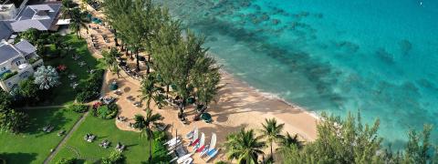 This image shows a beautiful, idyllic beach resort from an aerial perspective