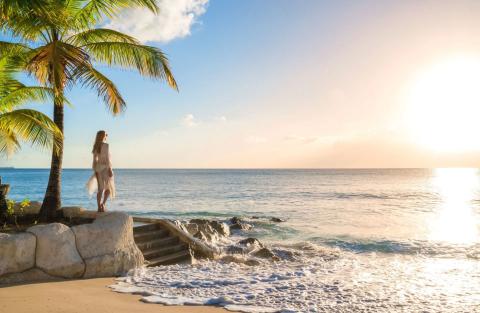 This image captures a serene beach scene at sunset