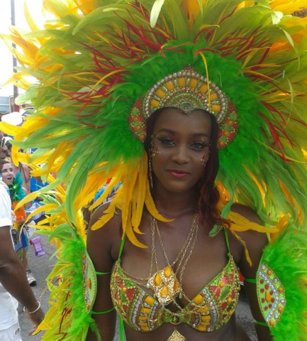 The image features a woman dressed in a vibrant and elaborate carnival costume