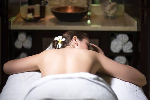 The image shows a person who appears to be relaxing at a spa