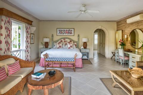 The image shows a well-decorated bedroom with a tropical or coastal design theme