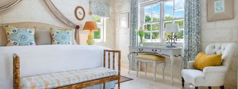 This image shows an elegantly decorated bedroom featuring a classic and airy design