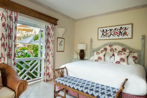 This image features a well-appointed bedroom with a tropical or coastal decor theme