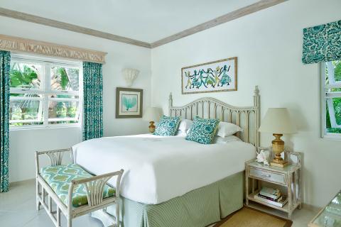 This image shows a neatly arranged tropical-style bedroom