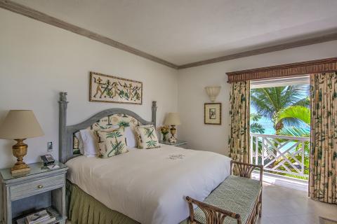 This image shows a beautifully decorated bedroom with a tropical resort theme