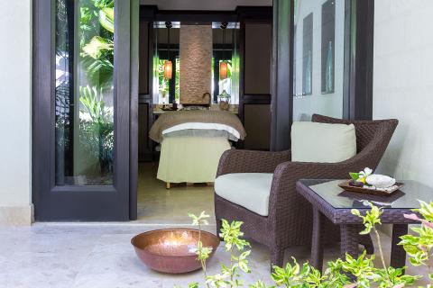 This image depicts a serene patio space that transitions into a tranquil indoor spa area