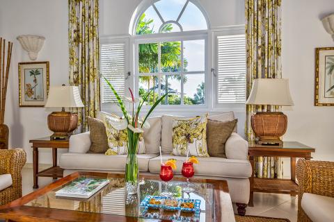 This image shows a beautifully decorated living room with a tropical style