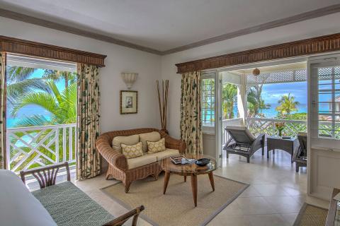 This image shows a beautifully decorated room with a tropical resort vibe