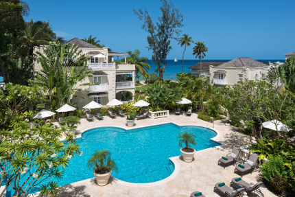 The image shows a luxurious outdoor setting of a resort or upscale residential area
