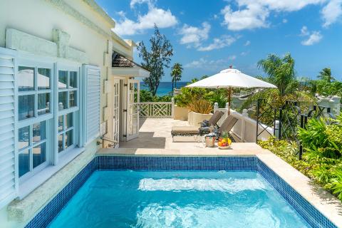 This image displays a luxurious exterior setting at a beachside property