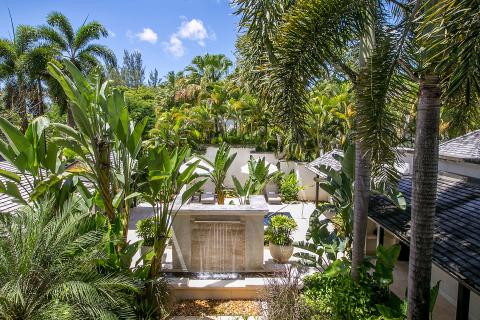 This image shows a tropical outdoor setting that appears to be part of a luxurious property