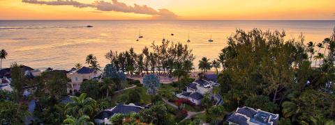 This image features a picturesque coastal scene at sunset