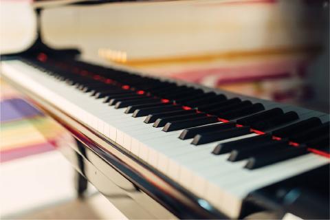 The image shows a close-up of a piano keyboard
