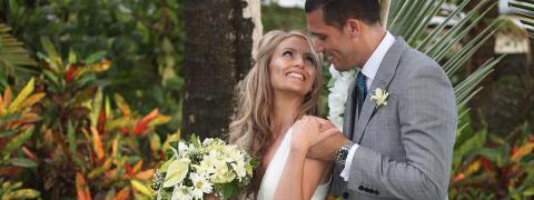 The image shows a bride and groom in an affectionate pose