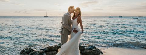 The image captures a romantic scene of a couple on their wedding day