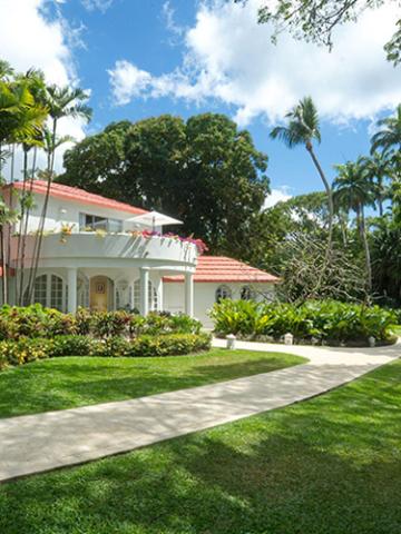 The image shows a two-story house with a red tiled roof and white walls