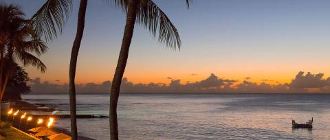 This image captures a tranquil beach scene at twilight