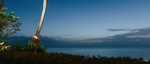 The image is a serene coastal scene at dusk