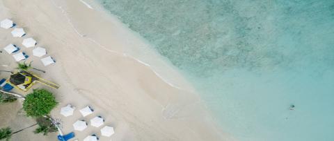 This image depicts an aerial view of a beautiful beach scene