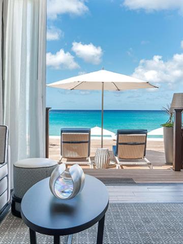 This image shows a serene beachfront view from a patio