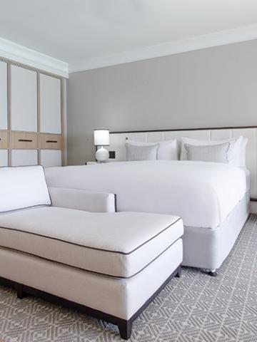 The image shows a modern hotel room or a similarly styled bedroom