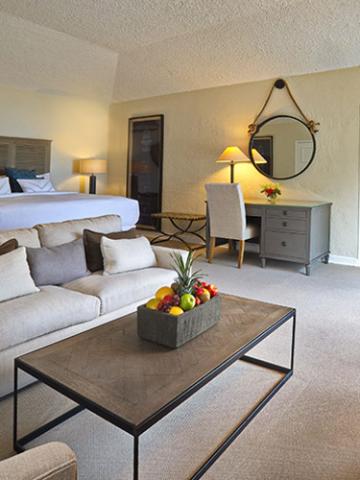 The image shows a neatly arranged room that appears to be a hotel or apartment suite