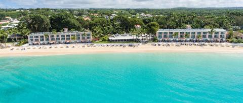 This image shows an aerial view of a luxurious beach resort
