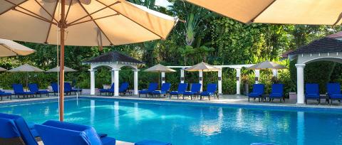 This image is of a luxurious pool area at a resort or hotel