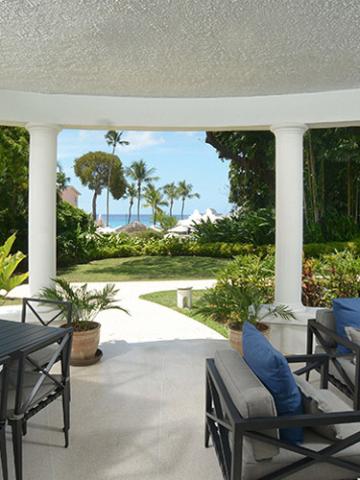 This image shows a stylish outdoor lounge area on a covered patio