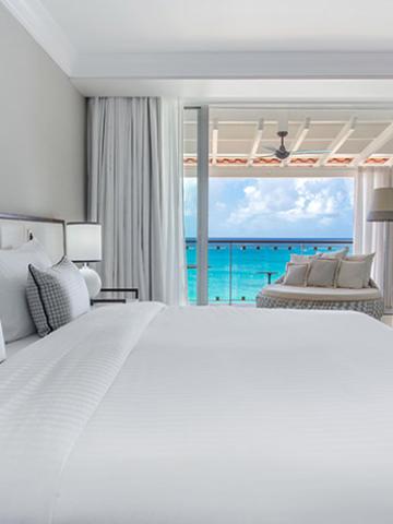This image shows a luxurious hotel room with a fantastic ocean view