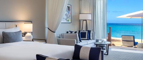 This image shows an elegant beachfront hotel room