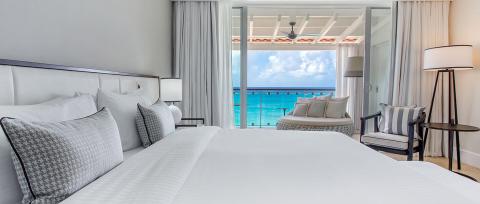 The image shows a luxurious hotel room with a contemporary design
