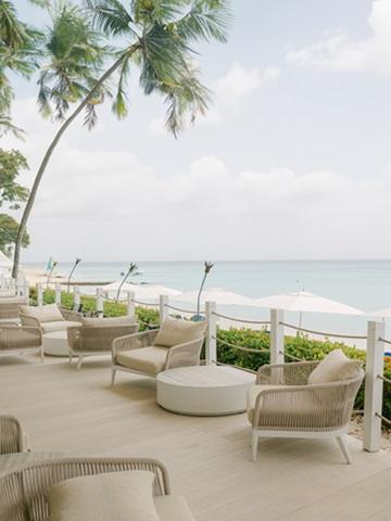This image shows a tranquil seaside outdoor setting, likely part of a resort or private residence