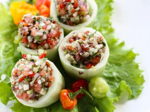 This image shows a colorful and appetizing preparation of stuffed cucumber rolls