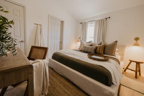 The image displays a cozy bedroom interior