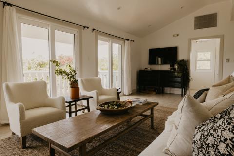 The image shows a well-decorated living room with a cozy and inviting atmosphere