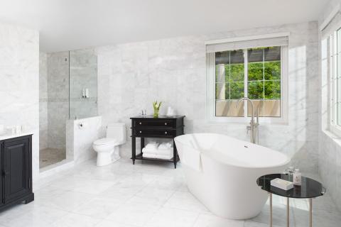 This image features a modern bathroom with a luxurious design
