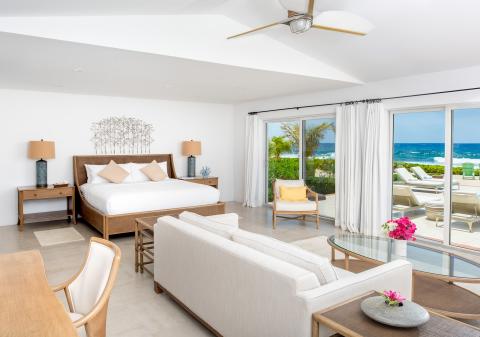 This image features a luxurious bedroom with a modern, elegant interior design