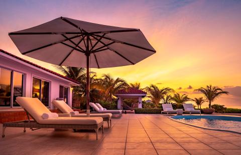 This image features a luxurious outdoor setting at sunset