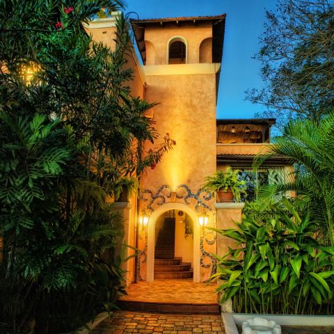 This image shows an enchanting evening view of a Mediterranean-style house